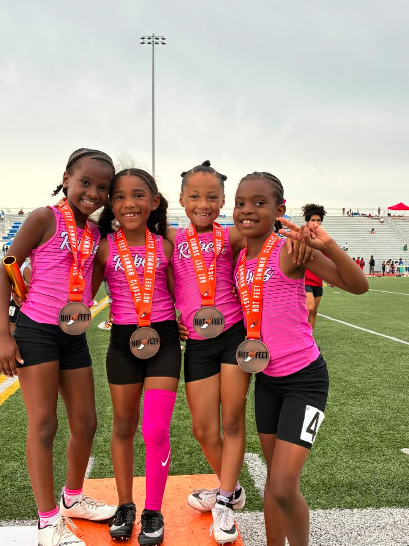 KC Rebels track and field athletes with medals